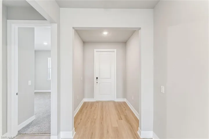 Hall with light hardwood / wood-style flooring