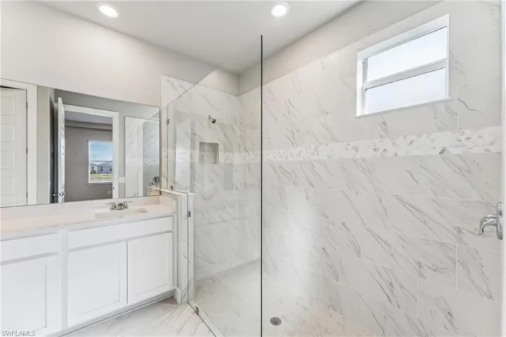 Bathroom with a tile shower and vanity