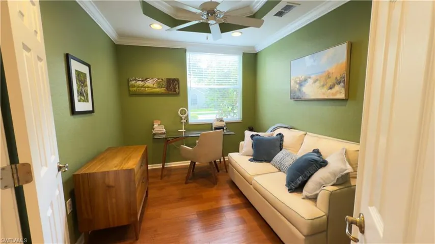 Office with wood finished floors, ceiling fan, and ornamental molding