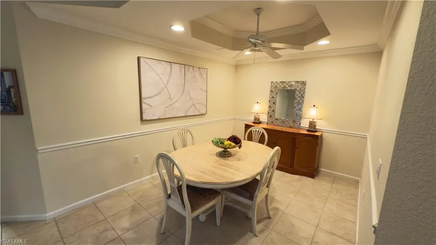 Dining space with crown molding and ceiling fan, recessed lighting, and a tray ceiling