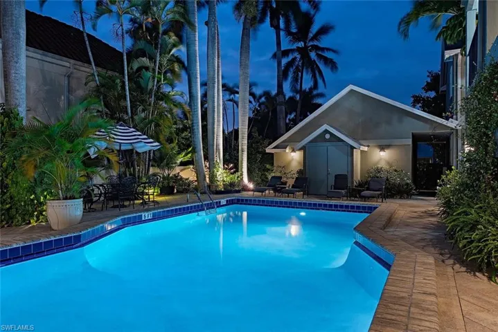 Swimming pool featuring a patio and an outdoor structure