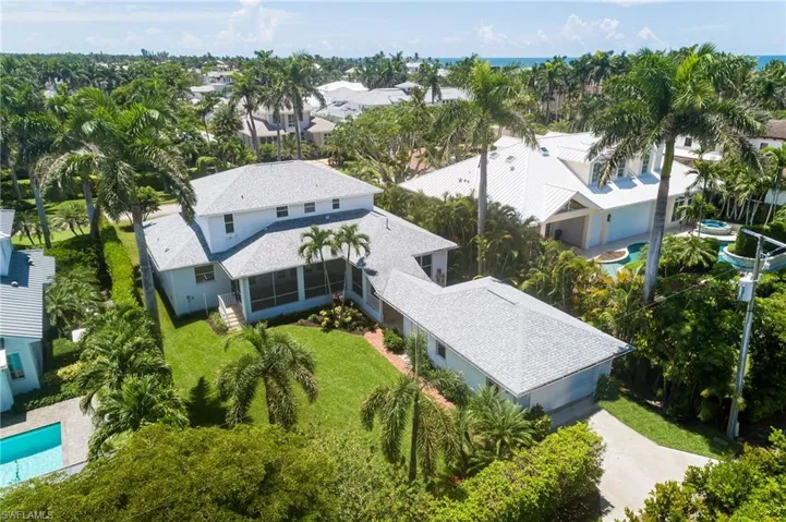 Aerial view of residential area featuring a pool