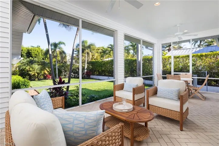 Sunroom / solarium with a ceiling fan and outdoor lounge area
