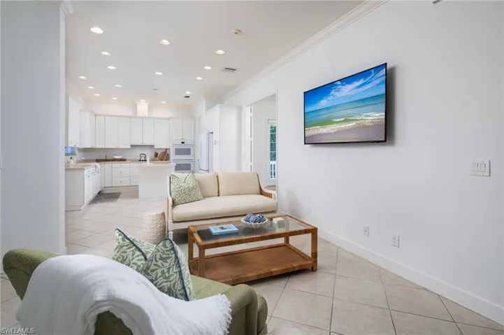 Living room featuring recessed lighting, light tile patterned floors, and ornamental molding