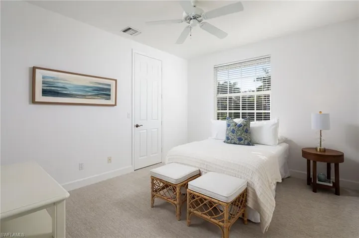 Bedroom with a ceiling fan and carpet flooring