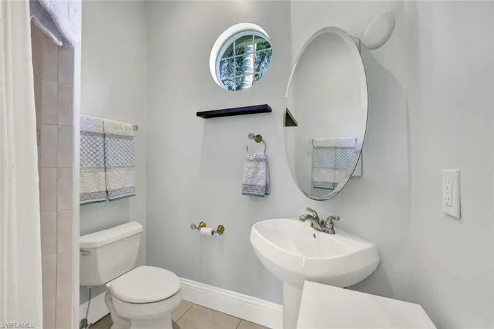 Casita bathroom featuring light tile patterned floors and toilet