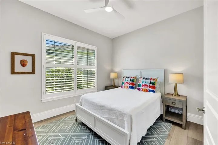 Bedroom with light wood-style floors and ceiling fan