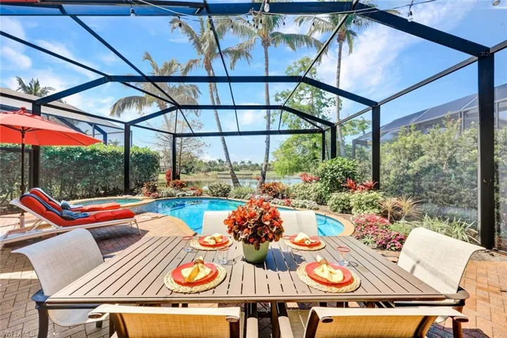 View of  refurbished pool (2018) with outdoor dining area, picture frame lanai enclosure (2018) , a water view, and a sunroom