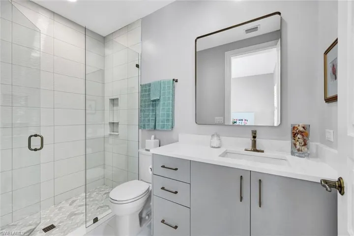 Bathroom featuring vanity and a stall shower