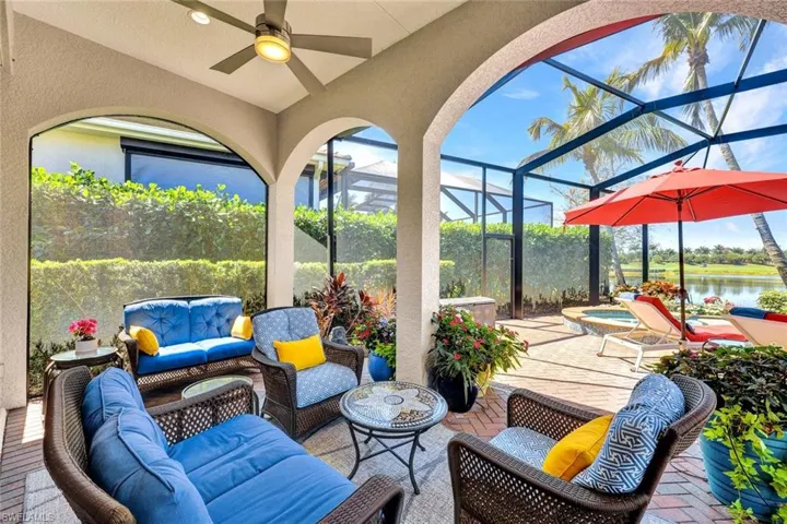 View of patio / terrace featuring outdoor lounge area, a sunroom, a lanai, an in-ground hot tub, and ceiling fan