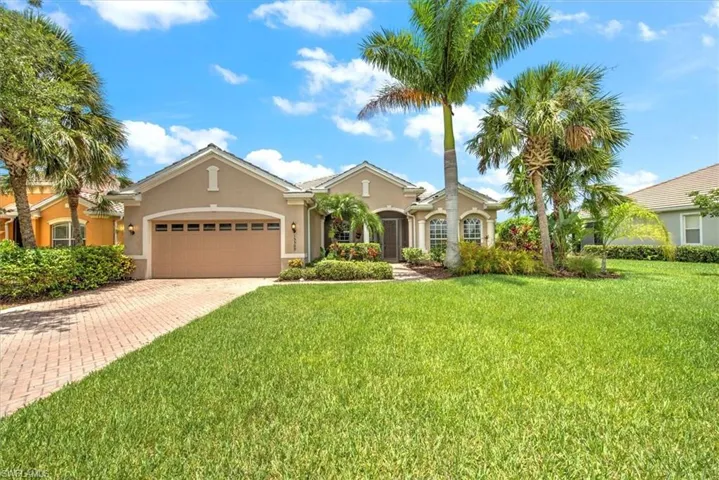 View of front of house with a garage and a front yard