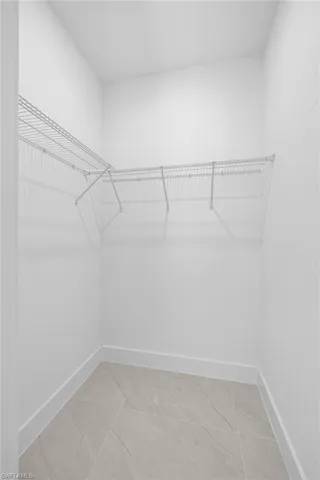 Spacious closet featuring tile floors