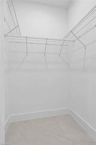 Spacious closet featuring tile floors