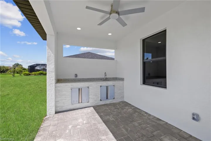View of patio / terrace with ceiling fan and sink