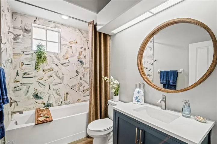 Full bath featuring vanity and shower / bath combo
