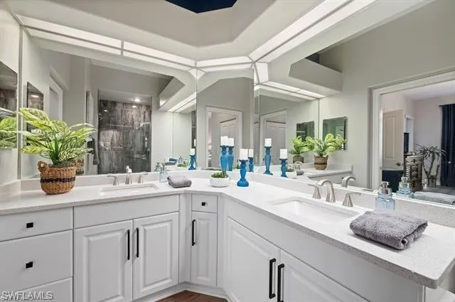 Full bath featuring a stall shower and double vanity