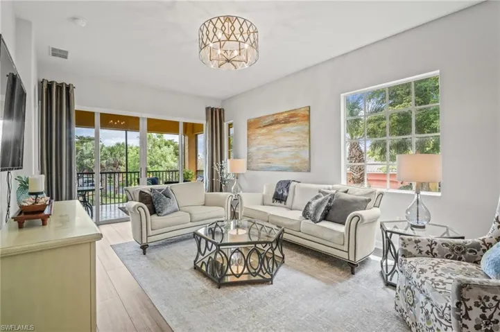 Living room featuring light wood finished floors and a chandelier