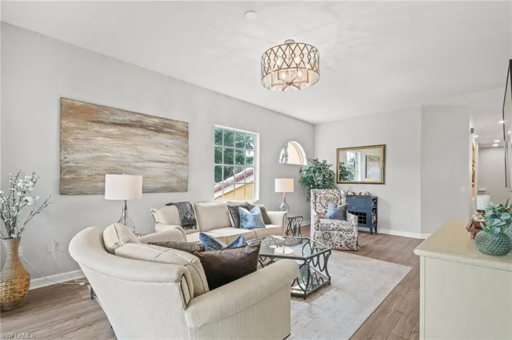 Kitchen featuring appliances with stainless steel finishes, tasteful backsplash, white cabinets, light wood finished floors, and recessed lighting