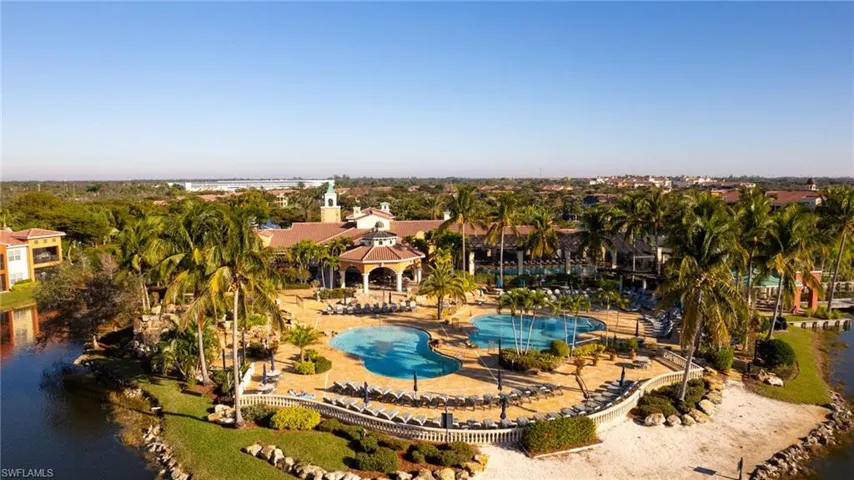 Aerial view of a pool area and a nearby body of water