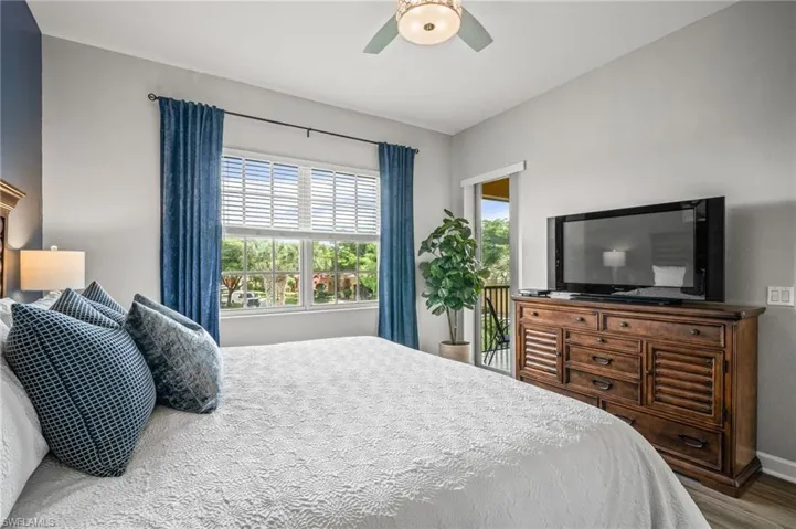 Bedroom featuring wood finished floors and a ceiling fan