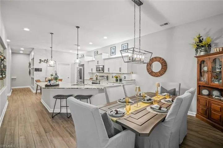 Dining space featuring recessed lighting, light wood-style flooring, and a chandelier