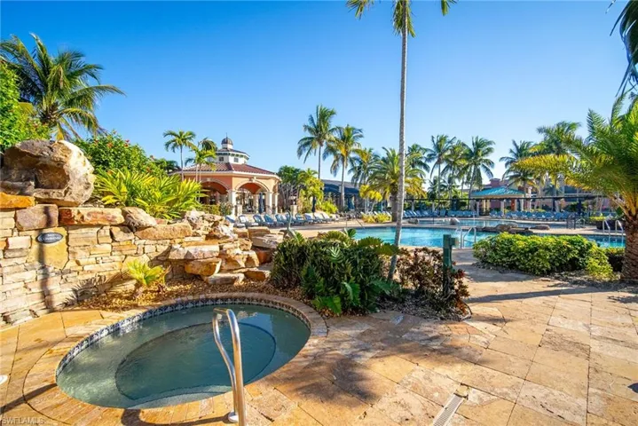 Community pool featuring an in-ground hot tub