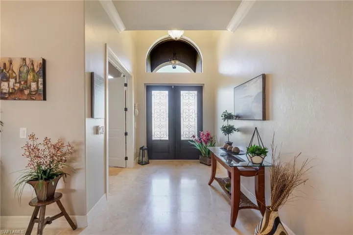 Entryway with crown molding and a high ceiling