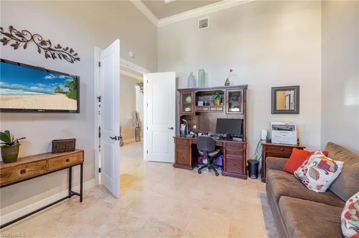 Office area with ornamental molding and baseboards