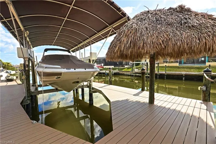 Dock area with boat lift, Tiki Hut and a water view. Electric and water at lift
