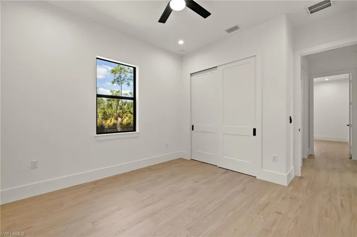 Unfurnished bedroom with visible vents, baseboards, and light wood-type flooring