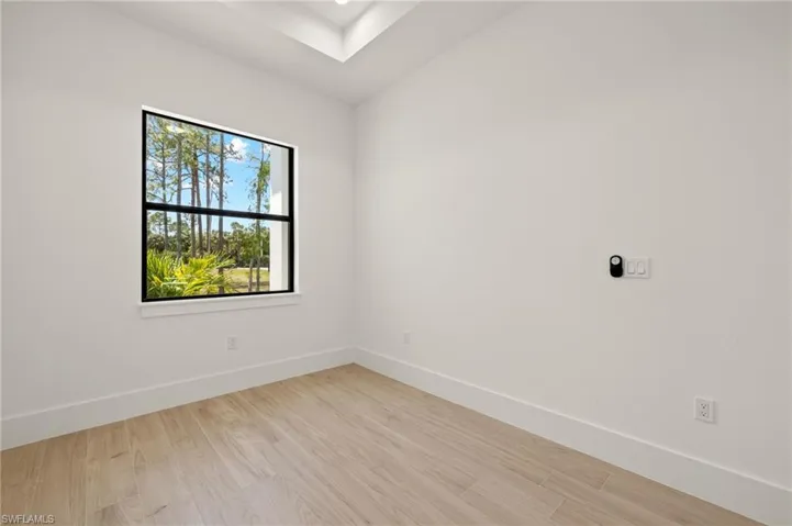 Empty room featuring light wood finished floors and baseboards