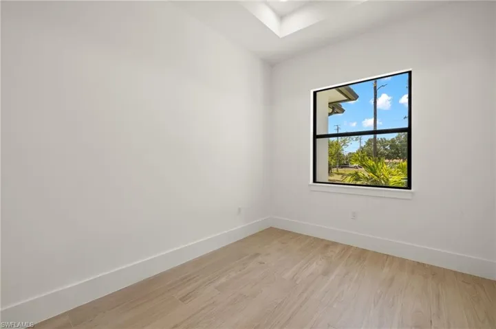 Empty room featuring baseboards and light wood finished floors