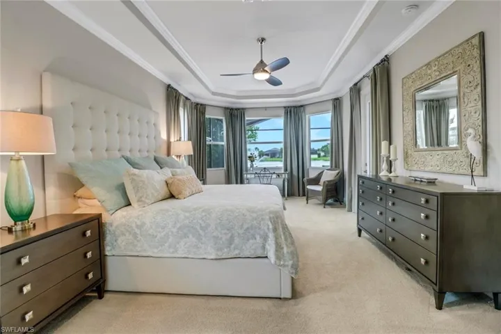 Master bedroom has a beautiful lake view, crown molding and spacious closets.