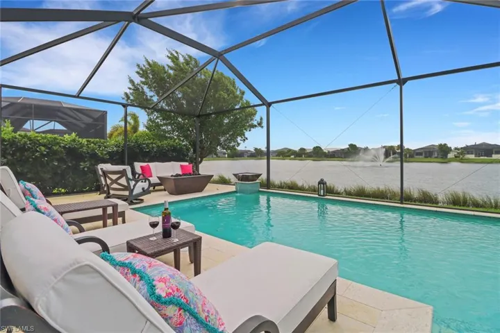 View of pool featuring a lanai, a patio area, and outdoor lounge area
