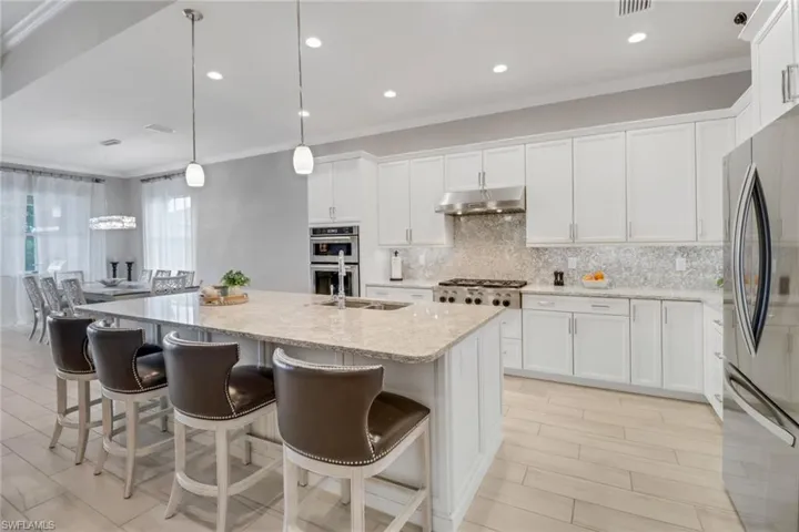Kitchen with quartz counters, upgraded stainless steel appliances, gas cooking and more.