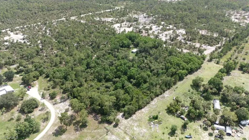 Expansive parcel featuring diverse tree cover and open grassy areas