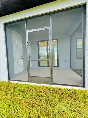 View of exterior entry featuring stucco siding