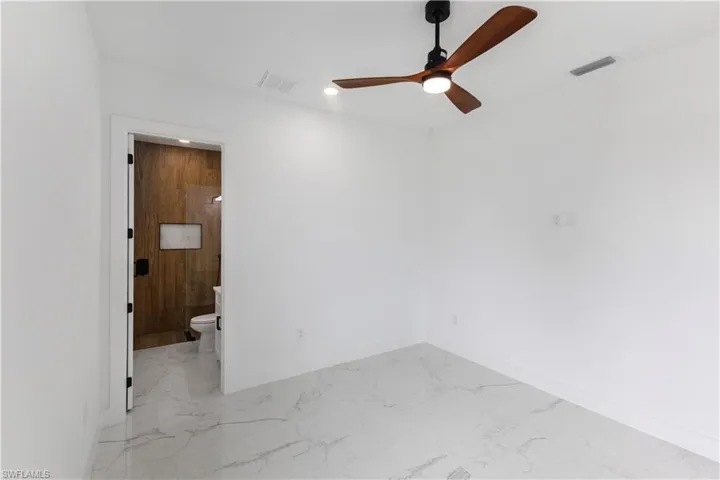 Unfurnished room with light marble finish floors, ceiling fan, and recessed lighting