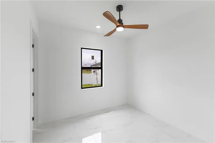 Unfurnished room with light marble finish floors, a ceiling fan, and recessed lighting