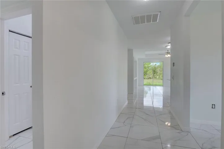 Hall featuring light tile floors