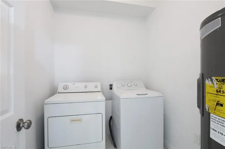 Tiled spare room featuring ceiling fan