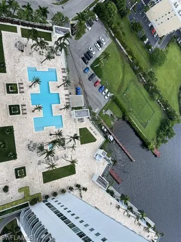 Aerial view of property's location with a pool and a nearby body of water