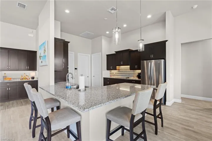 Gathering space around the kitchen for entertaining, but nto in the kitchen