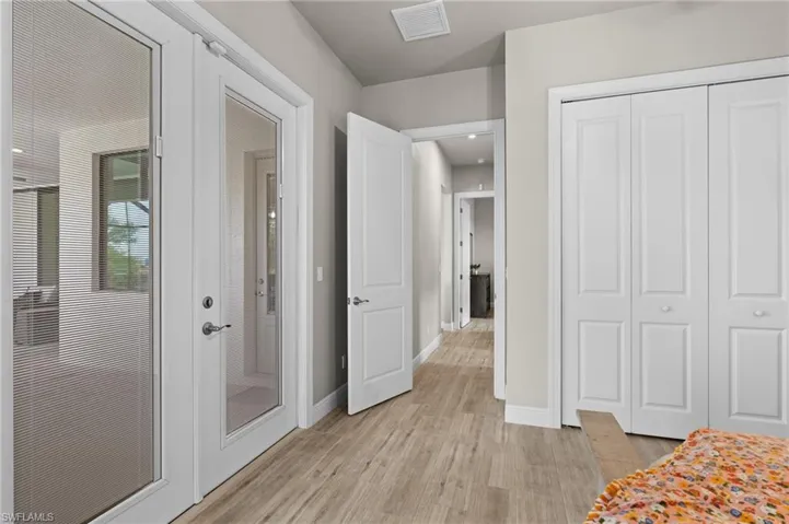 Doors in this bedroom also have built-in blinds for privacy, these doors exit to pool area.