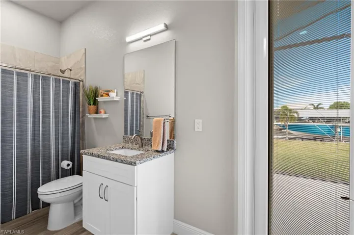 This third bathroom is a full bath with a shower.  You can see the built-in blinds on the door to the pool area.