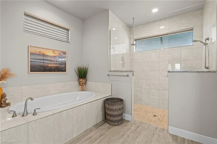 Dual shower heads and soaker tub.  Natural light with windows in the primary bath.