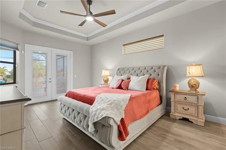 Primary bedroom with entrance to the lanai.  The doors have built-in blinds for privacy, a luxury feature you don't often see.