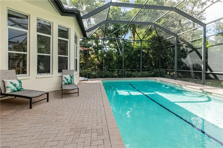 Outdoor pool featuring a patio area, a lanai, and a sunroom