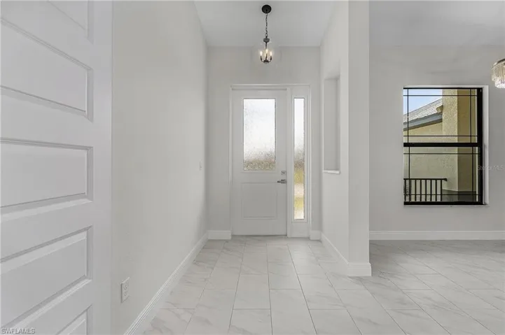 Foyer entrance featuring a wealth of natural light and light tile patterned floors