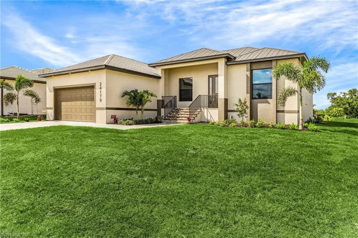 View of front of property with a garage and a front yard